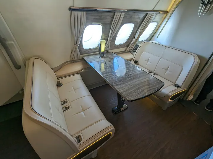 Club seats around a polished table in a compact cabin