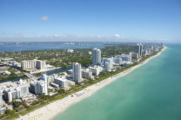 Miami Beach from the air, with hotels along a turquoise shoreline
