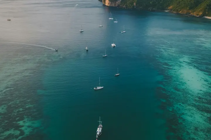 Boats moored in a turquoise tropical bay